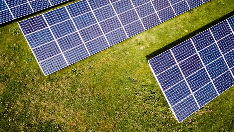Aerial view of a ground-mounted bifacial solar panel array